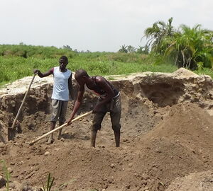 sand miners digging a pit in a wetland