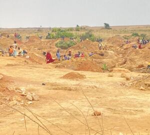 Workers digging up the ground at a mining site