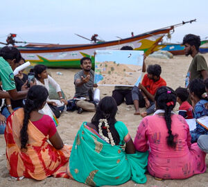 A group of people have learning session on a beach