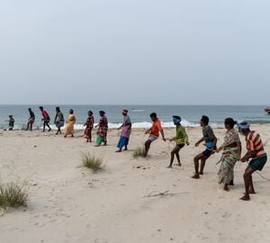 Local fishermen pulling net from the ocean