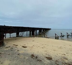 A beach with a view of the dock on Mannar Island