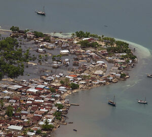 A photo of a coastal community flooding with water.