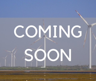 A field with several wind turbines, with text on top of it saying "Coming Soon"
