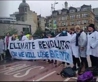 scientists on Glasgow major bridge protesting against failed COP26