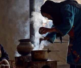 Women cooking food on a wood burner inside a mud house on the outskirts of Srinagar, India. Photo by: Sanna Irshad Mattoo / Reuters