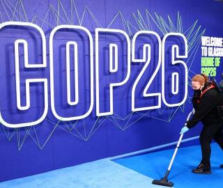 An employee cleans the podium before the arrival of leaders for the UN Climate Change Conference (COP26) in Glasgow, Scotland, Britain November 1, 2021. 