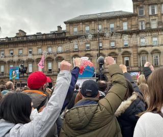 People raise their fist during a protest in Glasgow