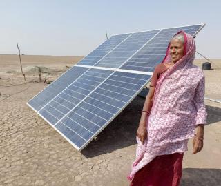 Kanuben, a salt worker, with her solar panel. Photo: Ravleen Kaur