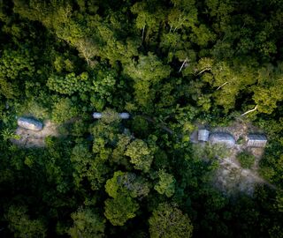 Aerial view of a Shiwiar Indigenous community in the Pastaza region of the Ecuadorian Amazon. Indigenous people are thought to protect 80% of the world’s remaining biodiversity, despite comprising just 6% of the global population. (Image: Mark Fox / Alamy)