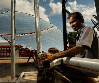 a man standing next to a small solar powered area