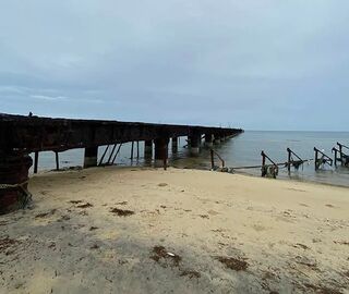 A beach with a view of the dock on Mannar Island
