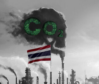 Thai flag waving with refinery in background