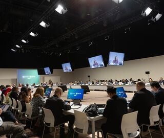 Large group of people sitting at a conference table.
