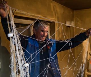 Fisherman Ivan Ivanov inspects his net