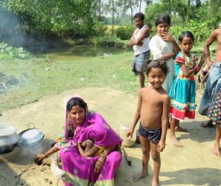 women and children outside their house in the sundarbans