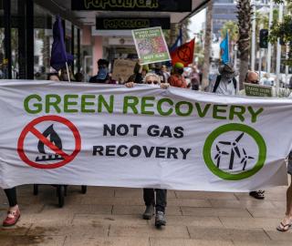 people in the streets protesting with a banner for green recovery in  Australia.