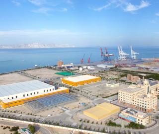 the Gwadar Free Zone and port area with warehouses and cranes at the waterline.