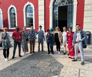 fellows in Lisbon in front of a red building