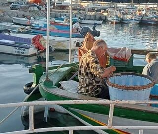 A fisherman on a boat in a port in Tunisia 