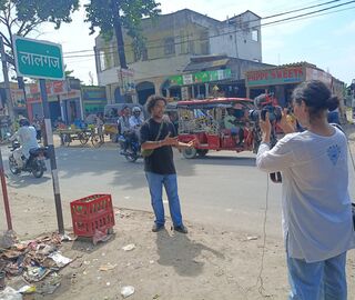 journalist filming an interview on the street