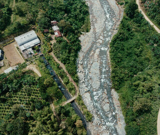 An aerial view of the San José del Tambo hydroelectric plant’s diversion channel and San Pablo de Amalí.